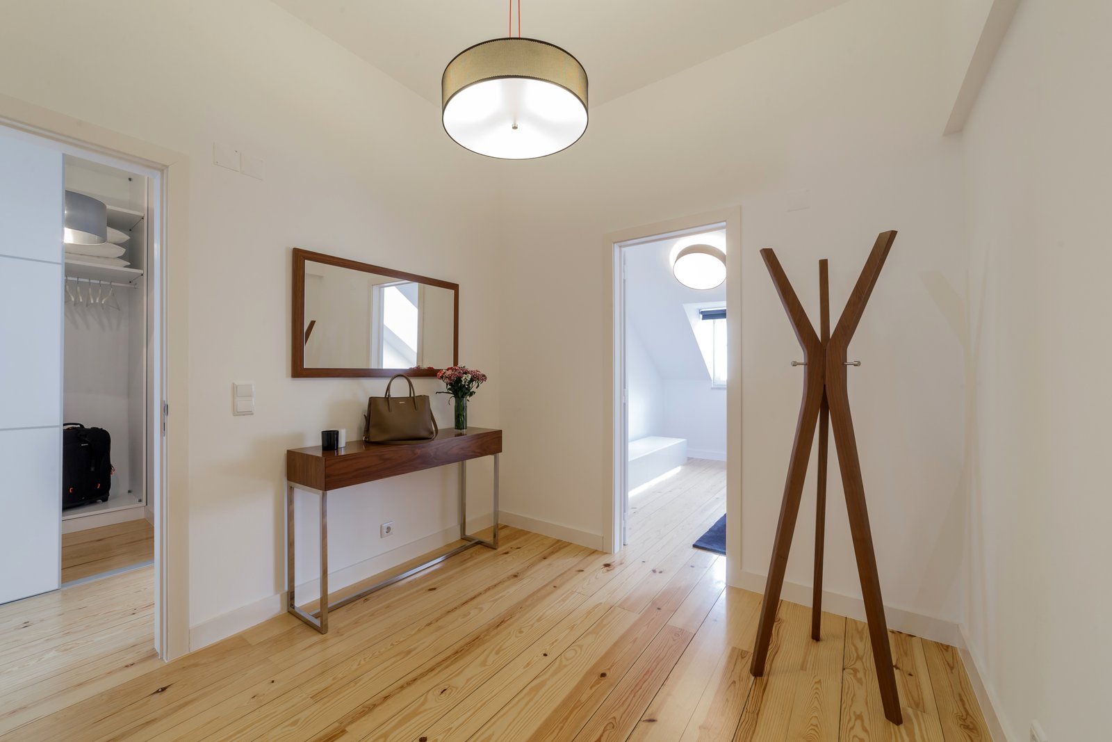 Modern apartment with white walls and light wooden floor
